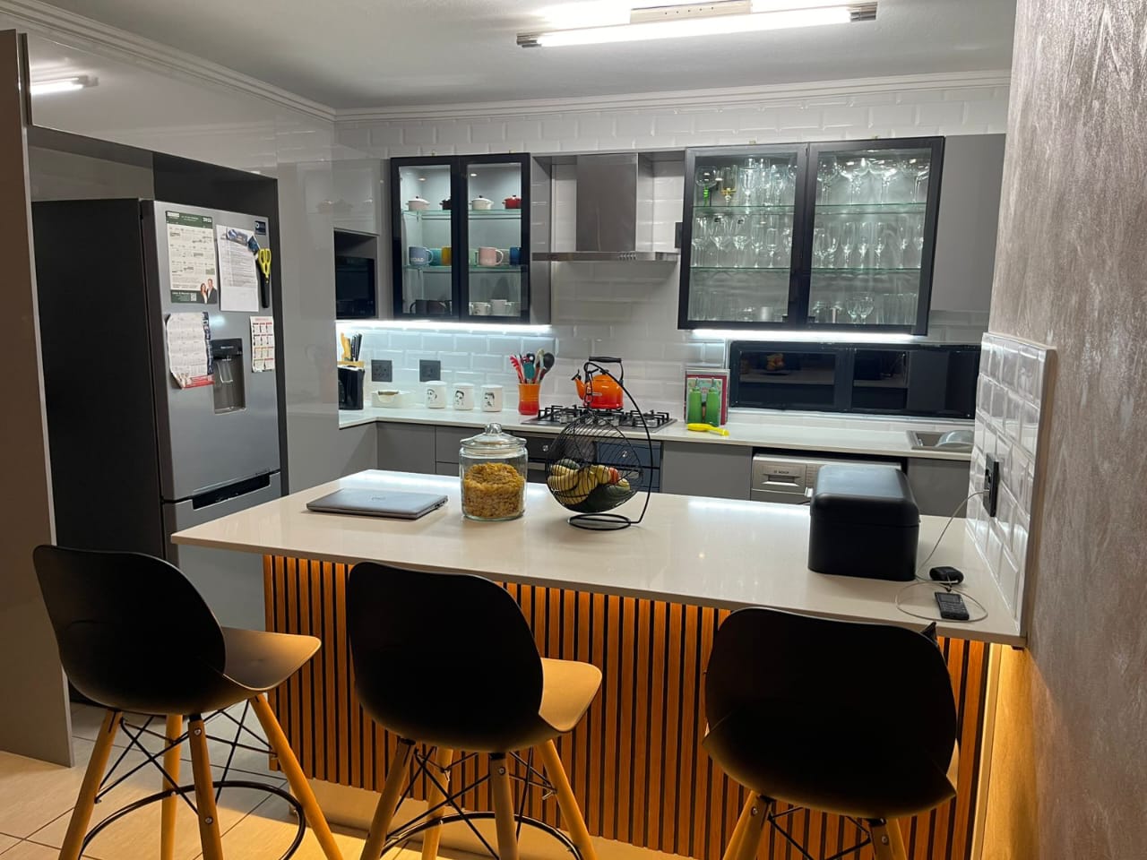 Modern kitchen with aluminium-framed glass cabinets